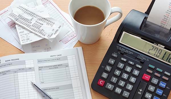 a calculator and a record sheet with reciepts